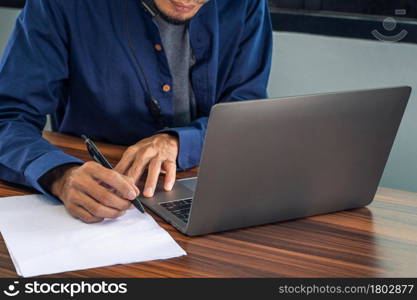 Man writing on document in office work with computer notebook, Business man work in home office ,People work from home