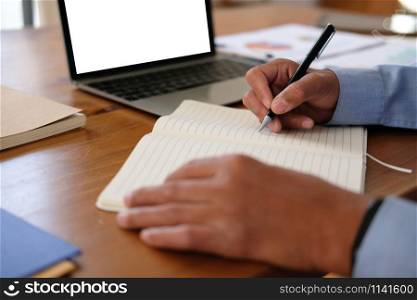 man writing reminder schedule note on notebook. businessman working organizing plan at workplace office