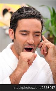 Man yawning on phone