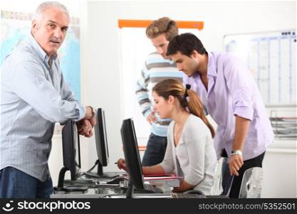 Manager and his team working at computers
