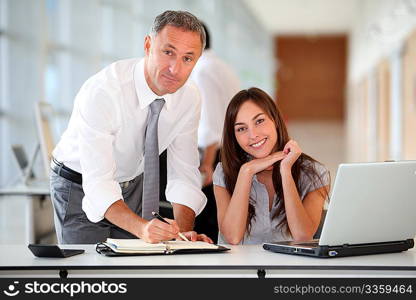 Manager and secretary working in the office