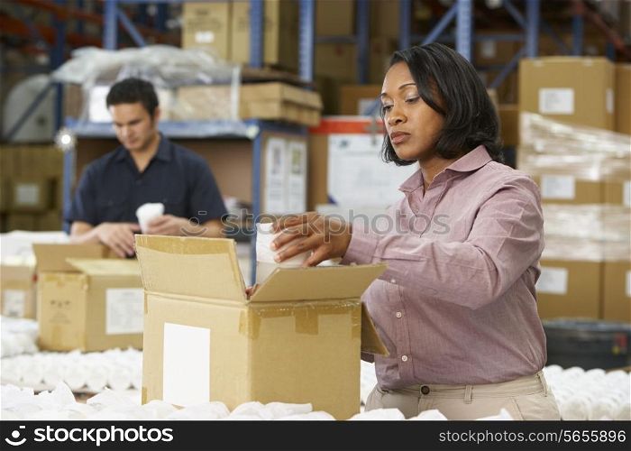 Manager Checking Goods On Production Line
