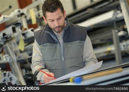 manager writing to clipboard at warehouse