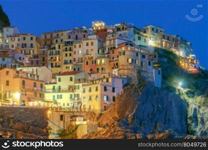 Manarola. Village on the rock.. A view of the colorful traditional houses on the rock on sunset. The coast of Liguria. Manarola. Cinque Terre.