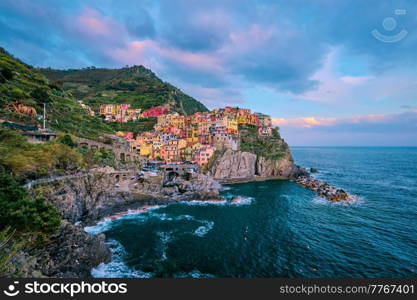 Manarola village popular european italian tourist destination in Cinque Terre National Park UNESCO World Heritage Site, Liguria, Italy on sunset. Manarola village on sunset, Cinque Terre, Liguria, Italy