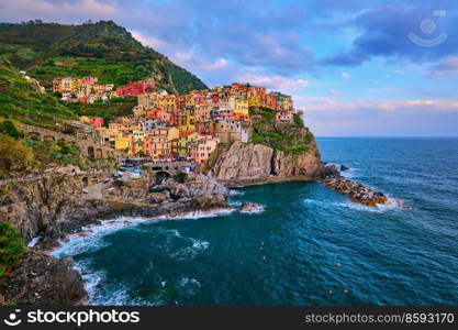 Manarola village popular european italian tourist destination in Cinque Terre National Park UNESCO World Heritage Site, Liguria, Italy on sunset. Manarola village on sunset, Cinque Terre, Liguria, Italy