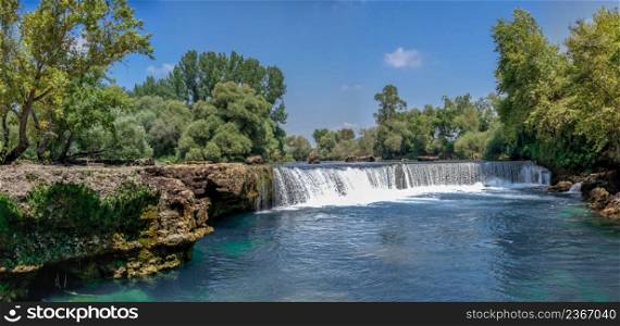 Manavgat waterfall and river in Antalya province of Turkey on a sunny summer day. Manavgat waterfall in Antalya province of Turkey