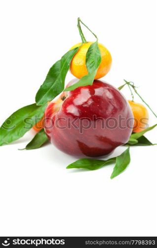 mandarin and an apple with green leaf isolated on white