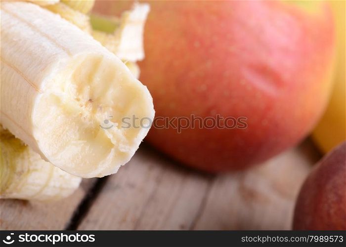 Mandarin Apples and Bananas on wooden plate