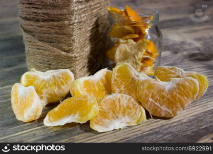 Mandarin slices on wooden background