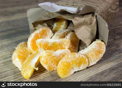 Mandarin slices on wooden background