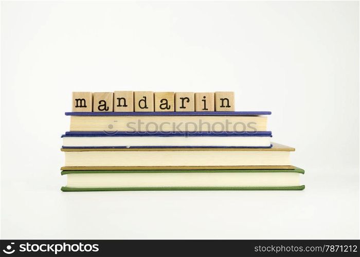 mandarin word on wood stamps stack on books, language and conversation concept