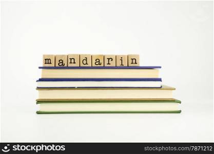 mandarin word on wood stamps stack on books, language and conversation concept