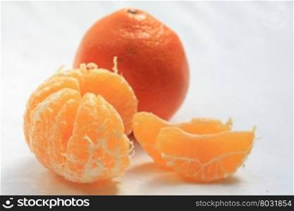 mandarine - tangerine, one unpeeled