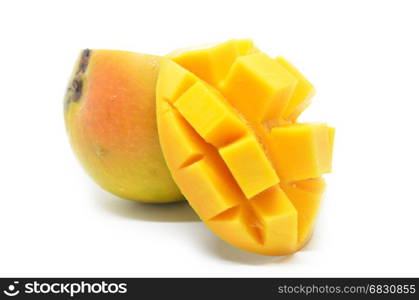 Mango cubes slices close up with mangos in white background