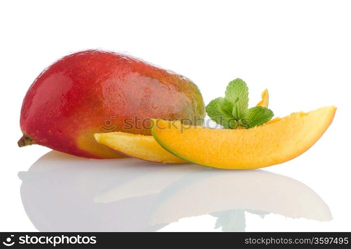 Mango fruit and slices on white reflective background.