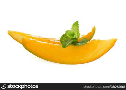 Mango fruit slices on white reflective background.