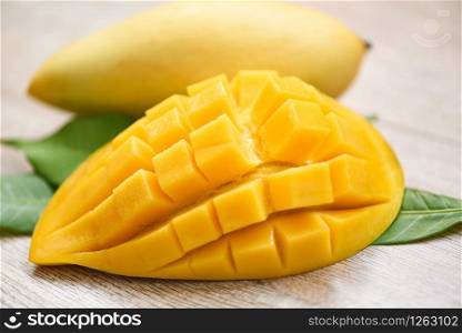 Mango slice and mango leaves from tree tropical summer fruit concept / Sweet ripe mangos cut half