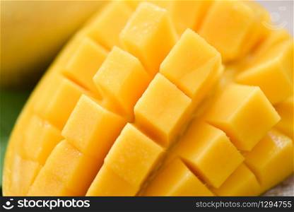 Mango slice and mango leaves from tree tropical summer fruit concept / Close up sweet ripe mangos cut