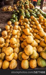 Mangoes are on display in neatly packed heaps at the fruit market in Stone Town, Zanzibar.