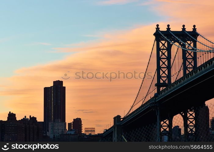 Manhattan Bridge and skyline silhouette view from Brooklyn in New York City at sunset