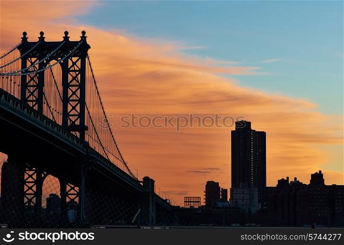 Manhattan Bridge and skyline silhouette view from Brooklyn in New York City at sunset