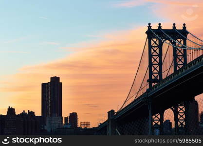 Manhattan Bridge and skyline silhouette view from Brooklyn in New York City at sunset