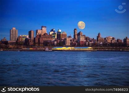 Manhattan Midtown skyline at dusk over Hudson River, New York City. super moon