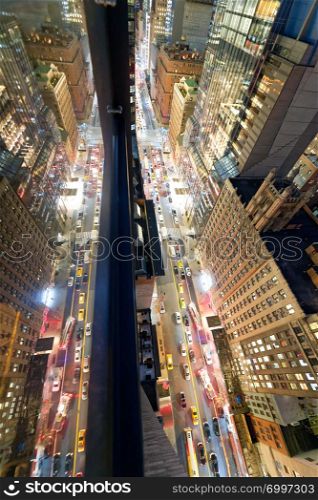 Manhattan, New York City. Night aerial view of city traffic from a high viewpoint with skyscrapers glass reflections.