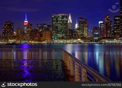 Manhattan New York skyline at sunset rainy dusk from East River NYC USA