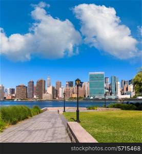 Manhattan New York sunny skyline from green park turf East River NYC USA