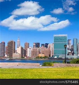 Manhattan New York sunny skyline from green park turf East River NYC USA