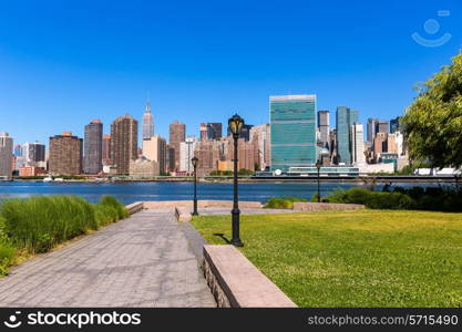 Manhattan New York sunny skyline from green park turf East River NYC USA