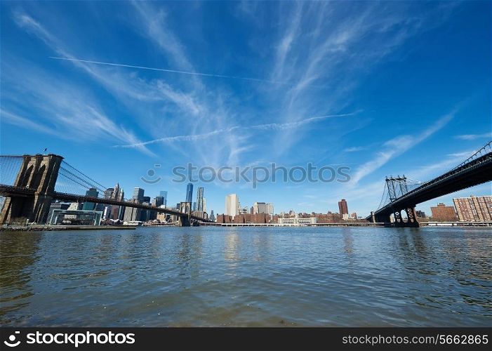 Manhattan skyline view from Brooklyn between Brooklyn Bridge and Manhattan Bridge in New York City