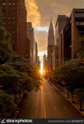 Manhattanhenge when the sun sets along 42nd street in NY. Sun setting along the length of 42nd street in New York city known as Manhattanhenge. Manhattanhenge when the sun sets along 42nd street in NY