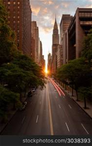 Manhattanhenge when the sun sets along 42nd street in NY. Sun setting along the length of 42nd street in New York city known as Manhattanhenge. Manhattanhenge when the sun sets along 42nd street in NY
