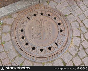 Manhole detail. LEIPZIG, GERMANY - JUNE 12, 2014: Detail of a manhole in the street