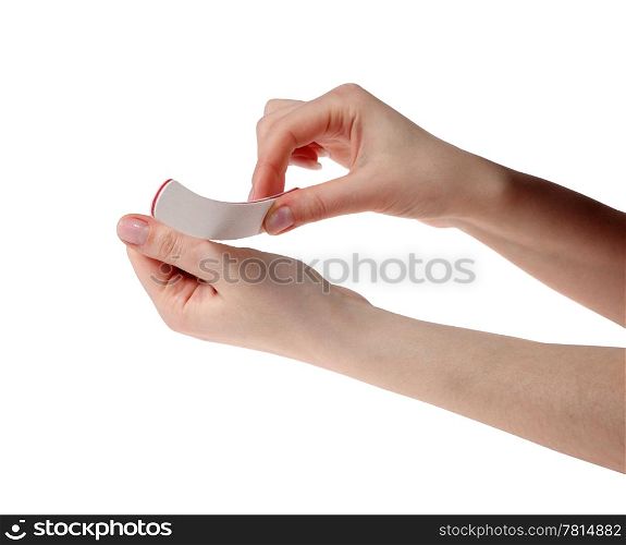 Manicure. Hands with the nail file on the white background