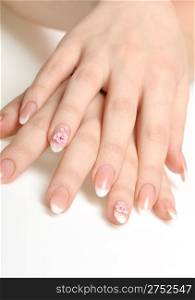 Manicure isolated on white. Well-groomed female hands with a decorative element - a flower