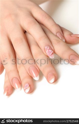 Manicure isolated on white. Well-groomed female hands with a decorative element - a flower
