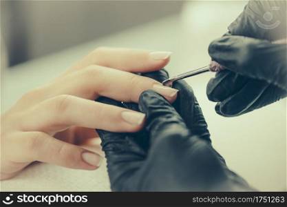 Manicuring nails in beauty salon