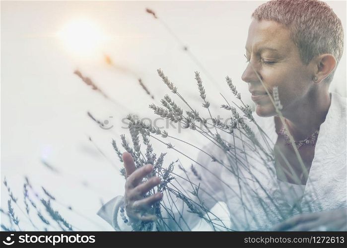 Manifesting Abundance. Mindful Woman Feeling Good, Enjoying the Scent of Lavender Flowers