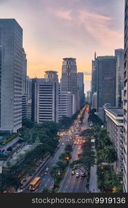 Manila, Philippines - Feb 01, 2020  evening view of the city of Makati. The skyscrapers against the bright setting sun. Manila, Philippines - Feb 01, 2020  evening view of the city of Makati. The skyscrapers against the bright setting sun.