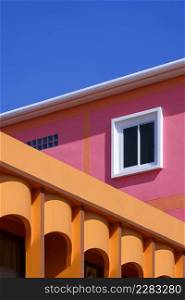 Manipulation techniques for colorful architectural background design of colonnade orange house with pink building against blue clear sky in perspective side view and vertical frame