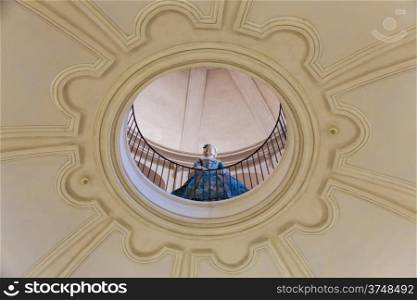 Mannequin dressed in old fashion (18th century). Interior of an old Italian palace.