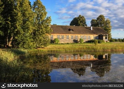 Manor house and pond at sunset, village Trigorskoye, Pushkinskiye Gory Reserve, Russia