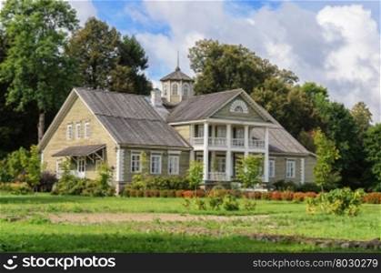 Manor house of P.A.Gannibal with a lawn and trees in the village Petrovskoye, Pushkinskiye Gory Reserve, Russia