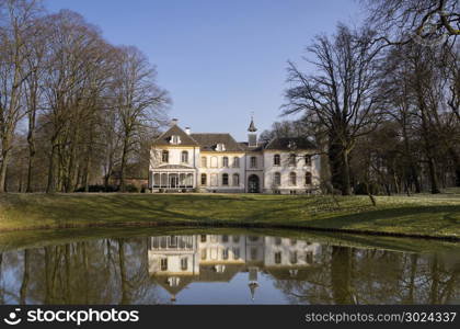 Manor house te Baak. View of the house in Baak reflecting in the canal near the village of the same name in the Dutch region Achterhoek