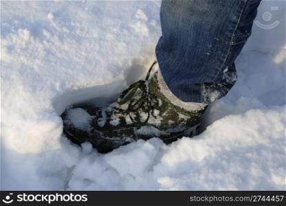 Mans boot making a footprint in deep snow, Warsaw, Poland.