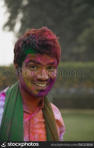 Mans face covered with holi colours